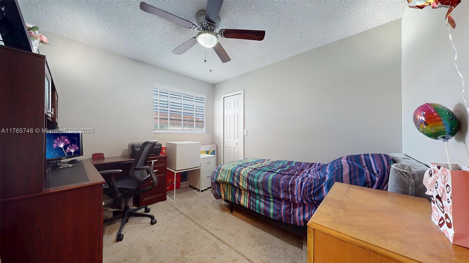 13539 Southwest 62nd Street, Unit 1 Miami, FL 33183 - Photo 32 of 38 a bedroom with a bed and a chandelier