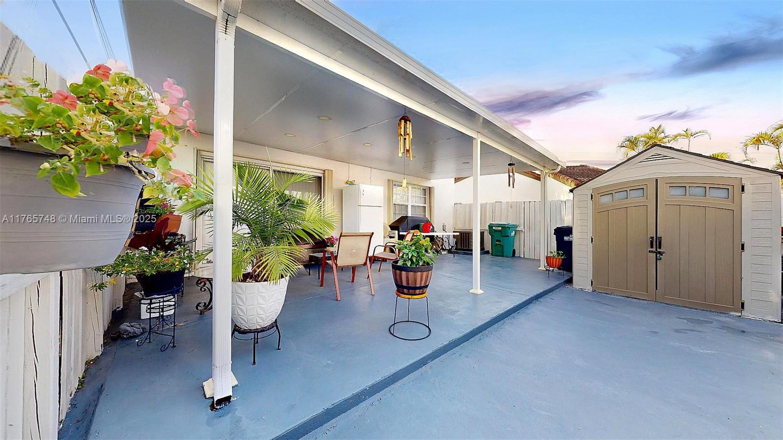 13539 Southwest 62nd Street, Unit 1 Miami, FL 33183 - Photo 35 of 38 a view of a porch with furniture