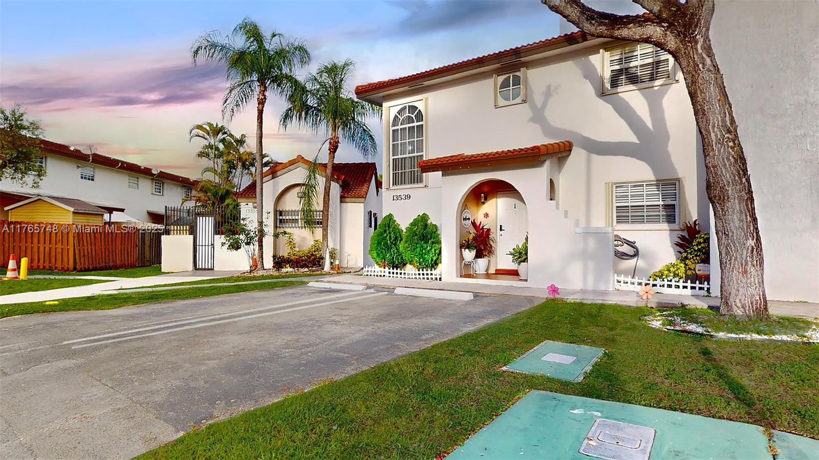 13539 Southwest 62nd Street, Unit 1 Miami, FL 33183 - Photo 4 of 38 a front view of a house with garden