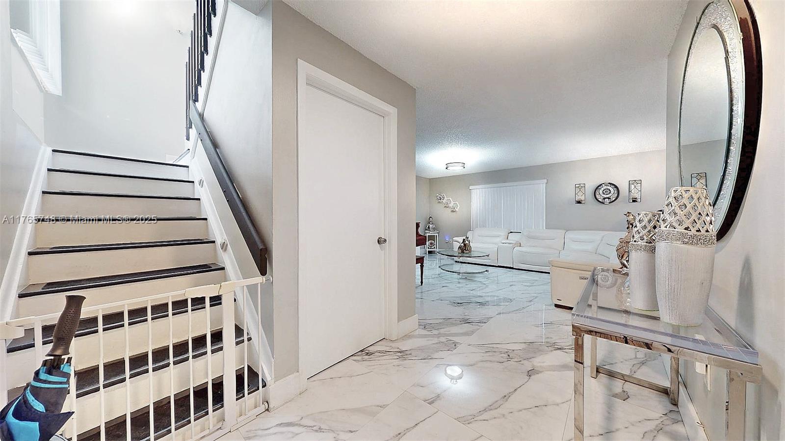 13539 Southwest 62nd Street, Unit 1 Miami, FL 33183 - Photo 8 of 38 a view of a living room with a fireplace and a chandelier