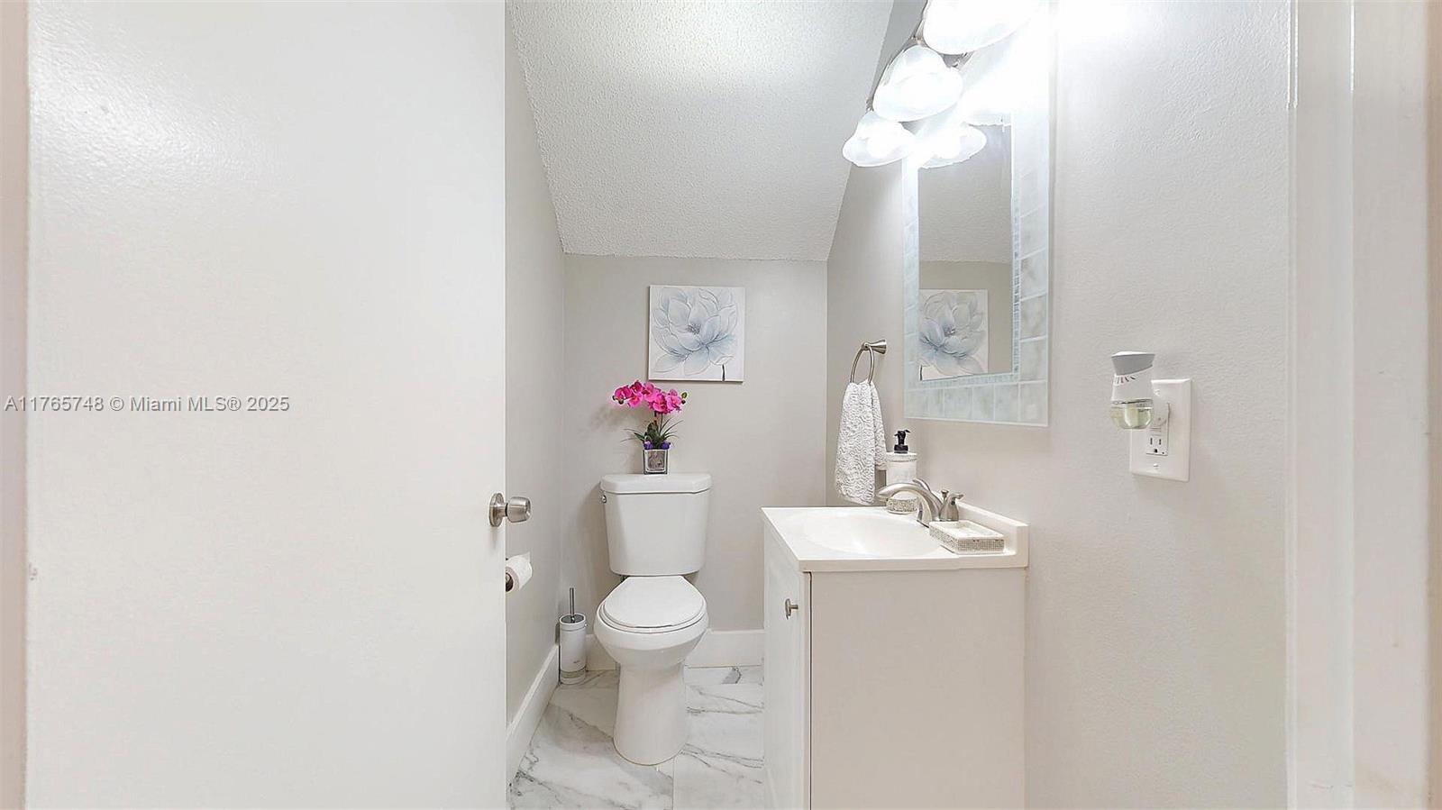 13539 Southwest 62nd Street, Unit 1 Miami, FL 33183 - Photo 10 of 38 a bathroom with a sink vanity and a mirror