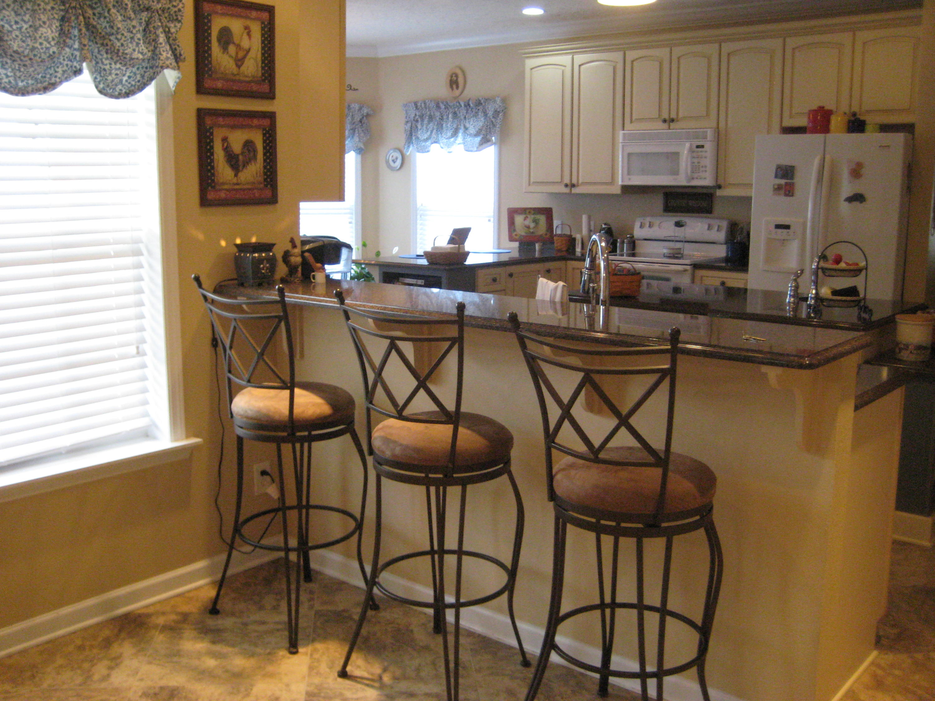 6024 Sand Hill Road Crestview, FL 32539 - Photo 32 of 43 a kitchen with stainless steel appliances granite countertop a stove a refrigerator and cabinets