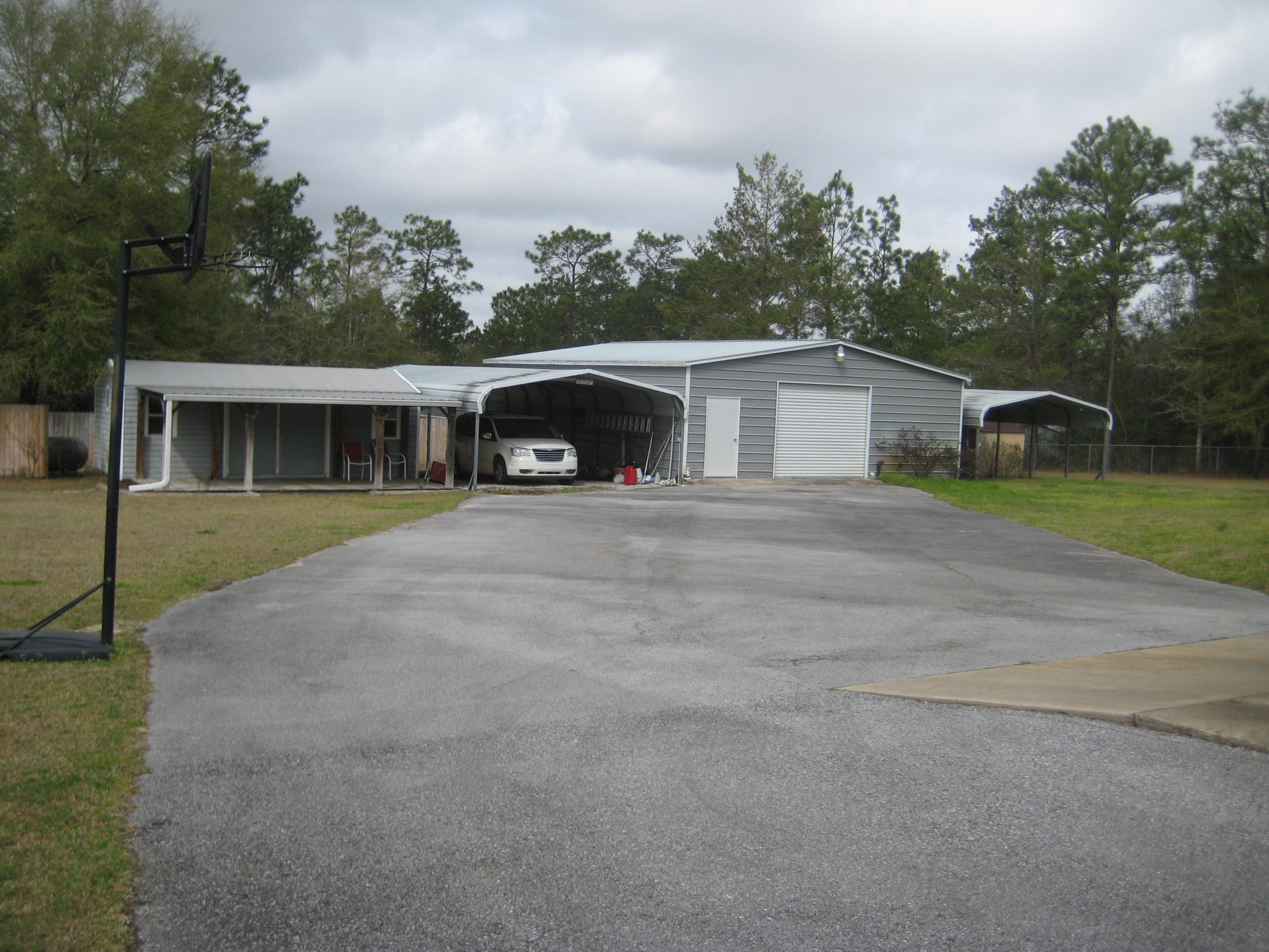 6024 Sand Hill Road Crestview, FL 32539 - Photo 7 of 43 a view of house with outdoor space and swimming pool