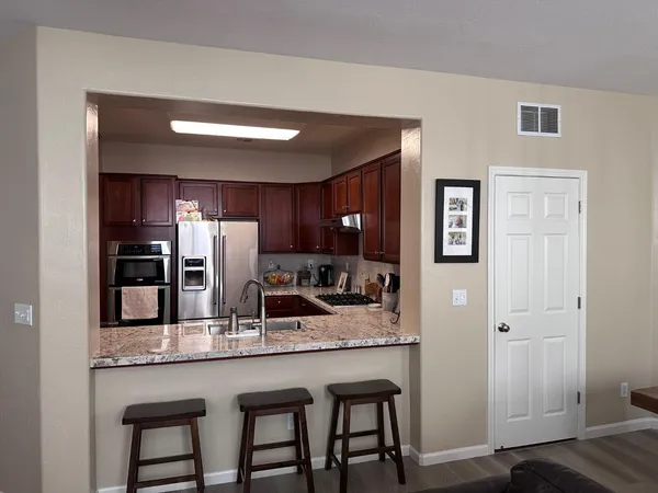 a kitchen with refrigerator and microwave