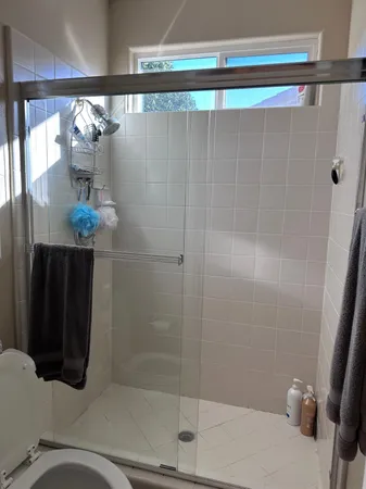 a bathroom with a shower and a sink