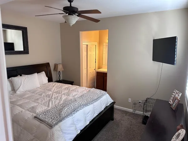 a bedroom with a bed and a flat screen tv
