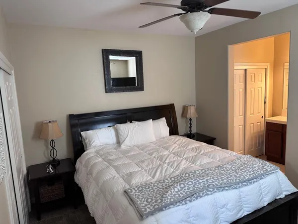 a large bed in a bedroom next to a window