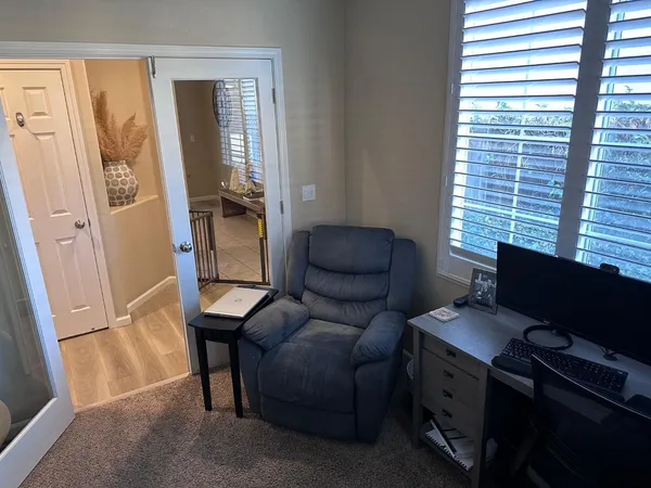 a livingroom with workspace and a window