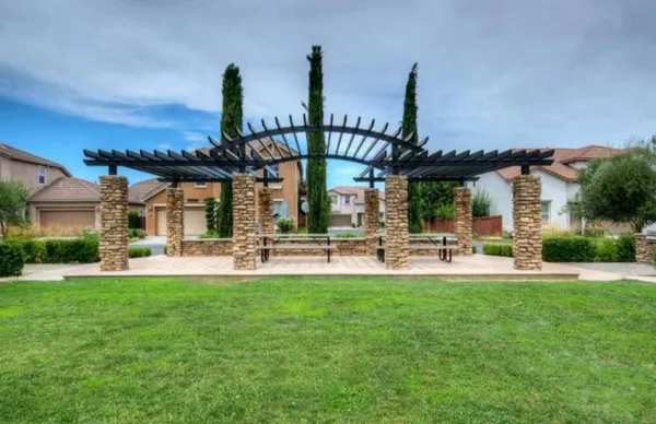 a view of a house with swimming pool and sitting area
