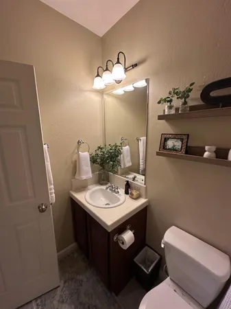 a bathroom with a toilet sink and mirror