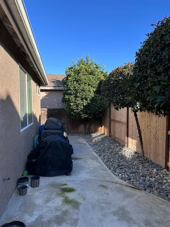 a view of a porch with furniture and a tree
