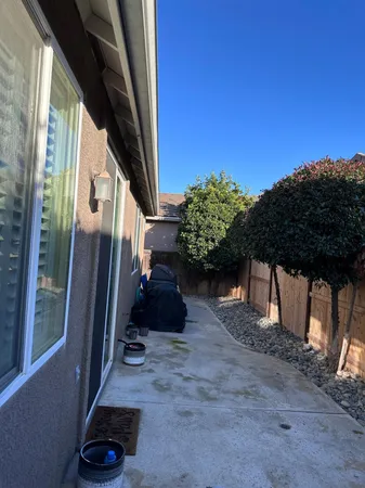 a view of a porch with furniture and a gate