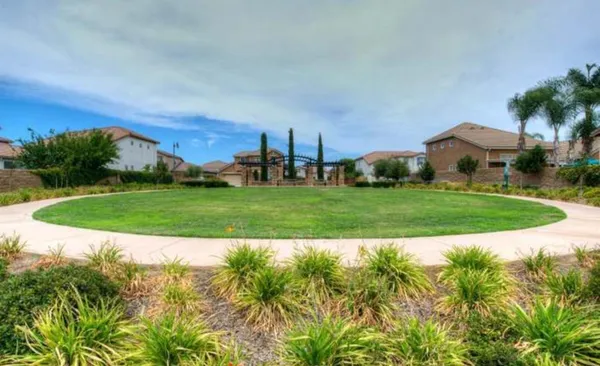 a view of a house with a yard and potted plants