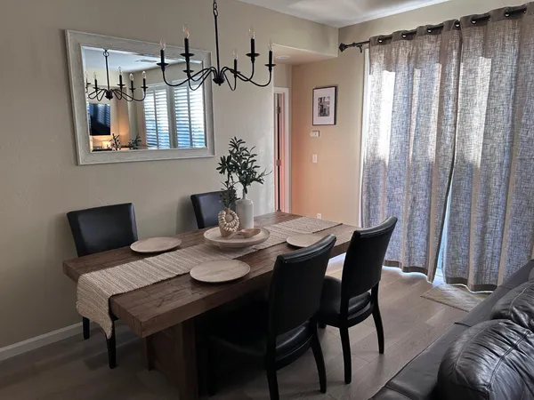 a view of a dining room with furniture and chandelier