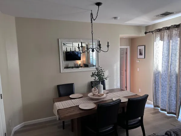 a view of a dining room with furniture and wooden floor