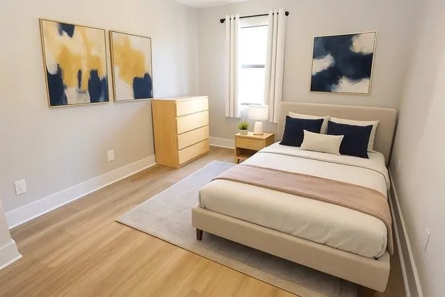 a spacious bedroom with a bed and a window