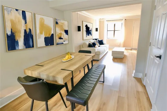 a view of a dining room with furniture and wooden floor