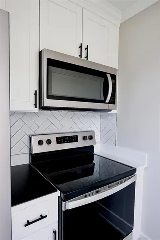 a stove top oven sitting inside of a kitchen
