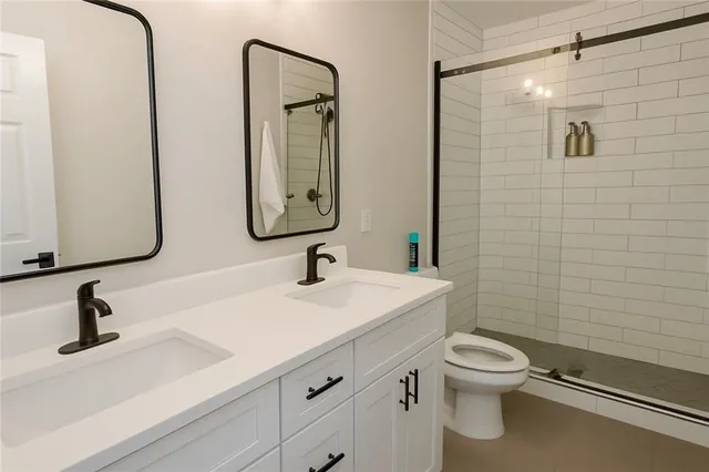 a bathroom with a toilet sink and mirror
