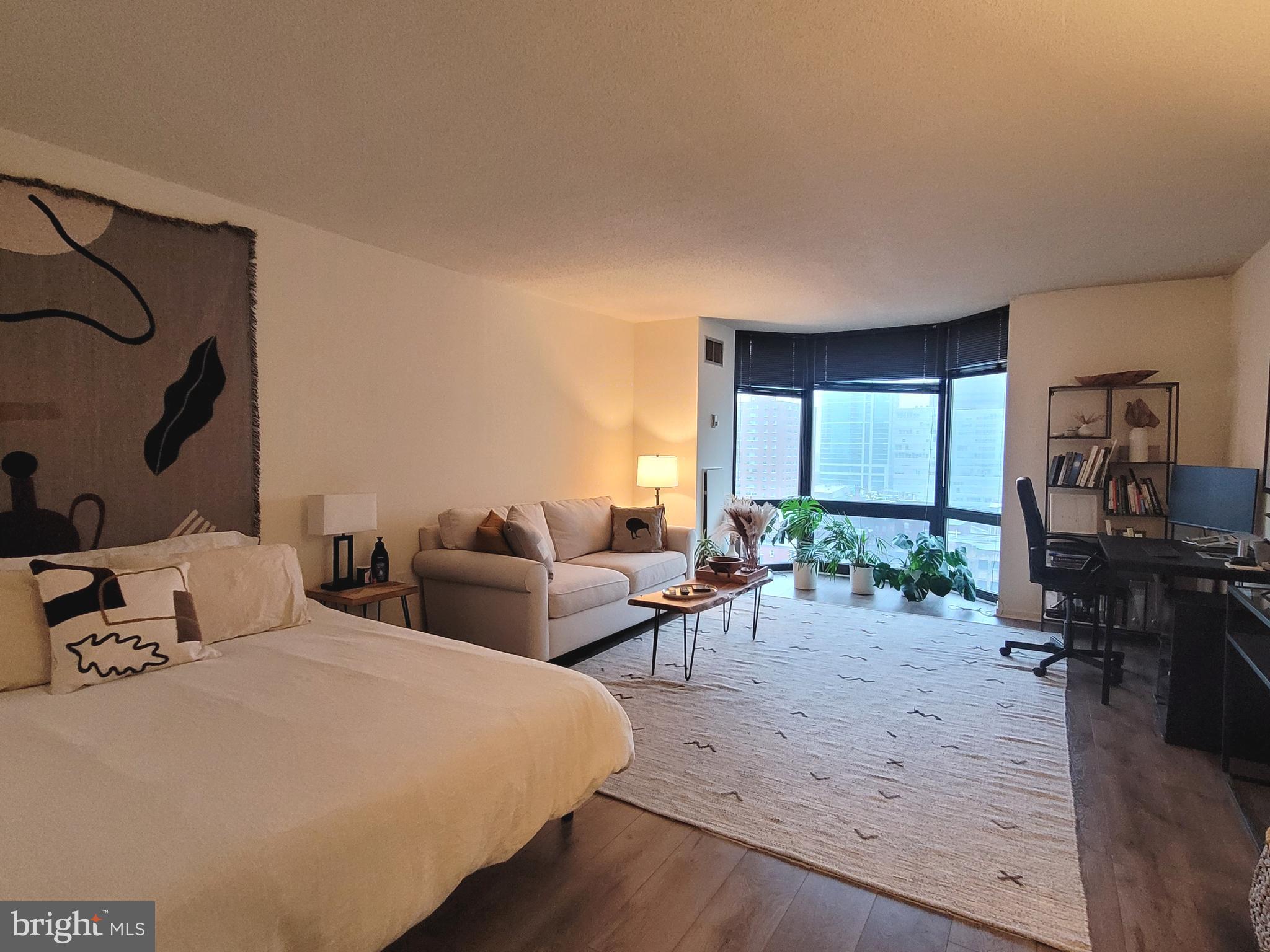 2020 Walnut Street, Unit 11A Philadelphia, PA 19103 - Photo 1 of 20 a bedroom with a bed a large window and wooden floor