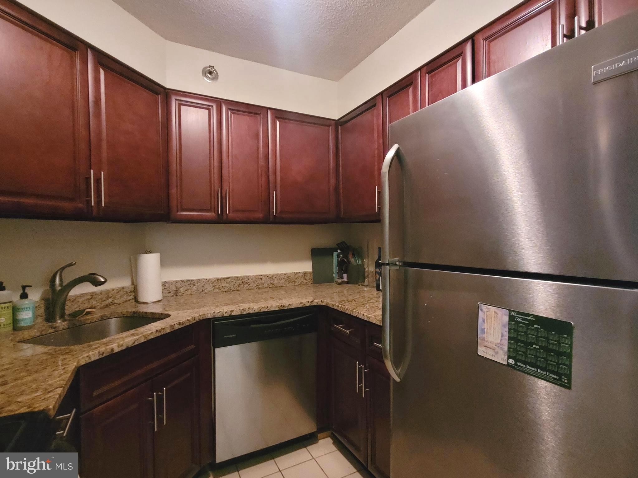 2020 Walnut Street, Unit 11A Philadelphia, PA 19103 - Photo 7 of 20 a kitchen with stainless steel appliances granite countertop a refrigerator a sink and a stove