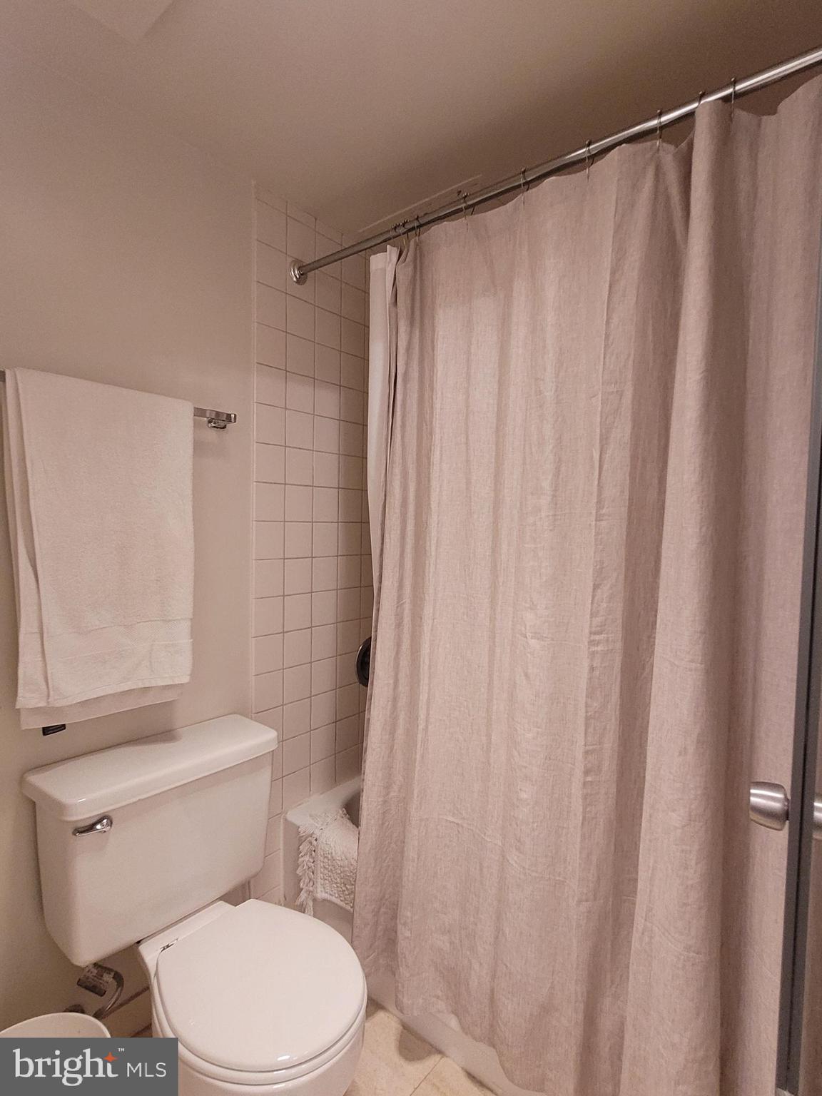2020 Walnut Street, Unit 11A Philadelphia, PA 19103 - Photo 9 of 20 a white toilet sitting next to a shower curtain