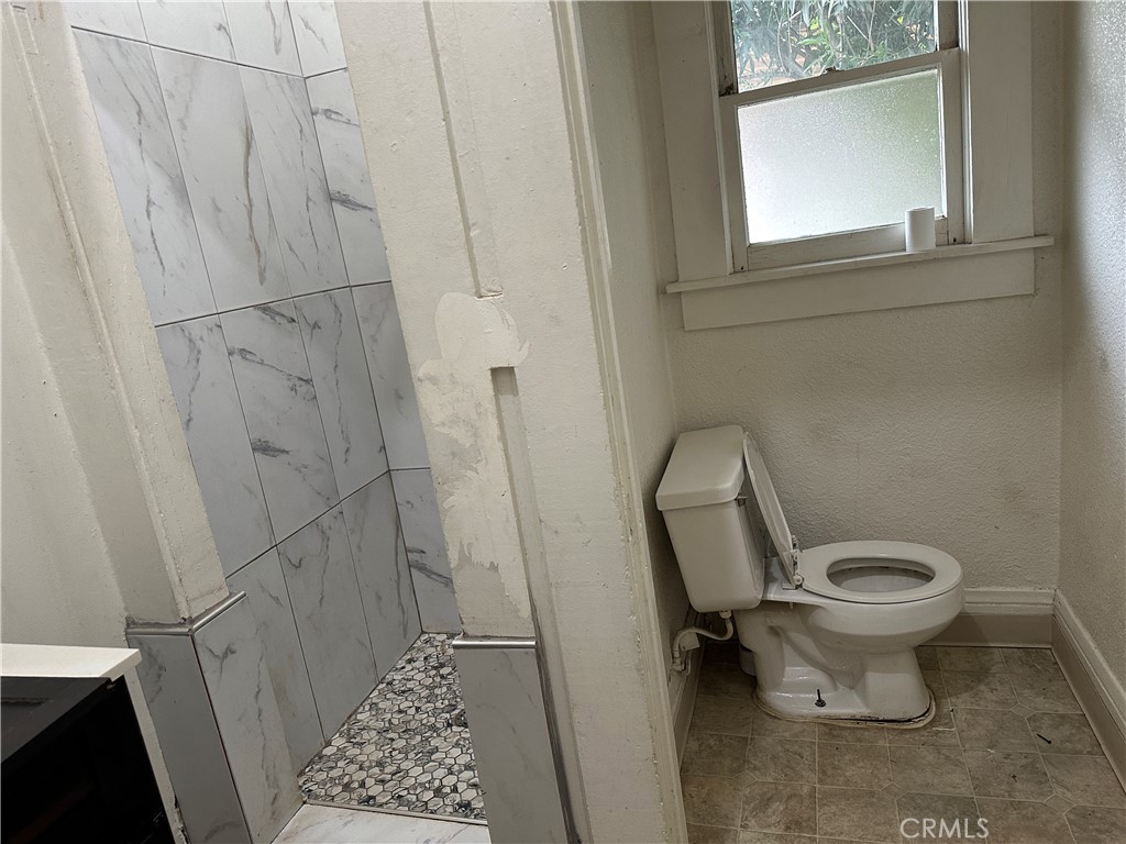 50 West 20th Street Merced, CA 95340 - Photo 15 of 20 a bathroom with a toilet and a shower