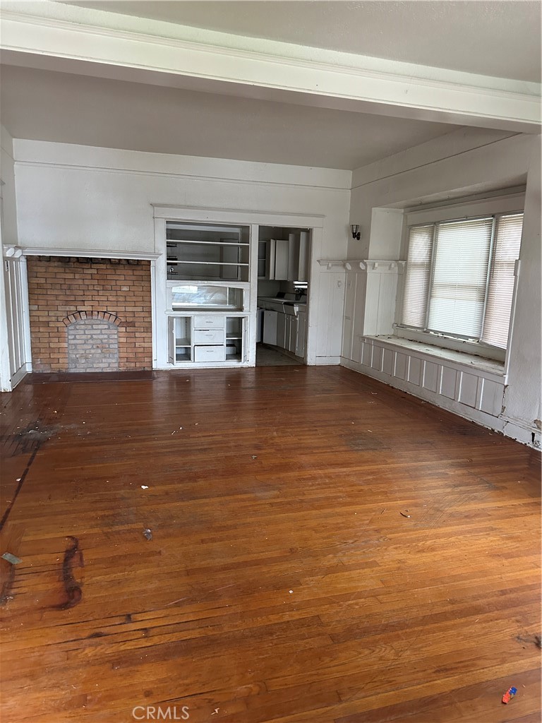 50 West 20th Street Merced, CA 95340 - Photo 5 of 20 a view of an empty room with wooden floor and a window
