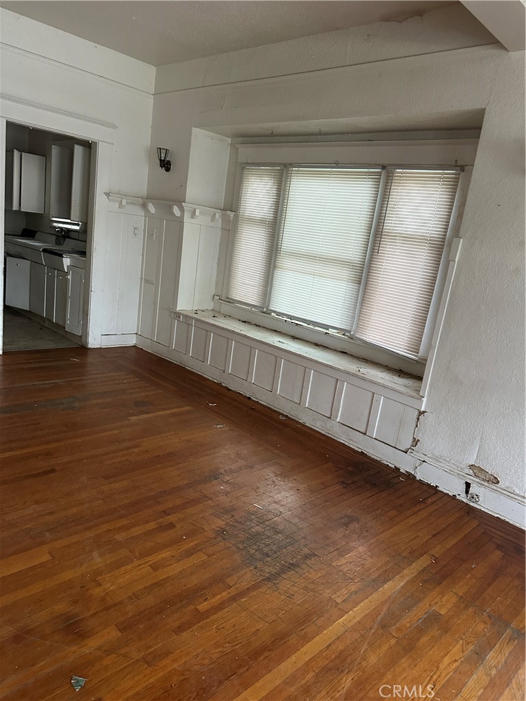 50 West 20th Street Merced, CA 95340 - Photo 7 of 20 a view of an empty room with wooden floor and a window