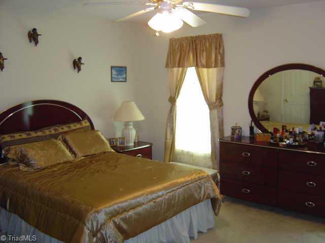 3610 Markham Road Greensboro, NC 27405 - Photo 6 of 7 Other. Master Bedroom his & hers walk-in closets, ceiling fan w/light kit, neutral carpet, paint.