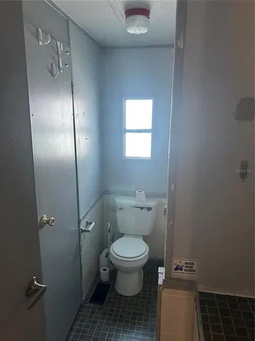 a white toilet sitting next to a sink