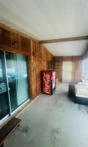 a view of a swimming pool with a yard and palm trees