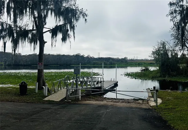 a view of a lake with a bench and trees