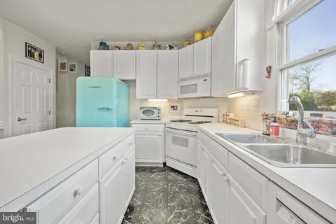 a kitchen with cabinets and white appliances