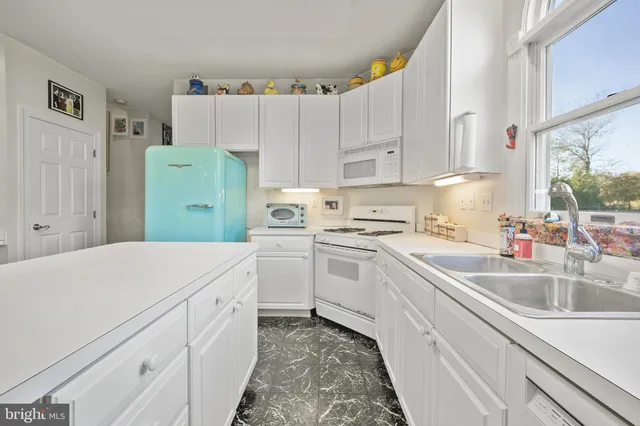 a kitchen with cabinets and white appliances