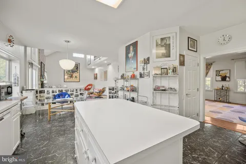 a large kitchen with lots of counter space and living room view