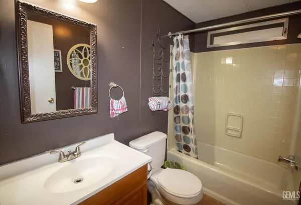 a bathroom with a toilet a sink and a shower