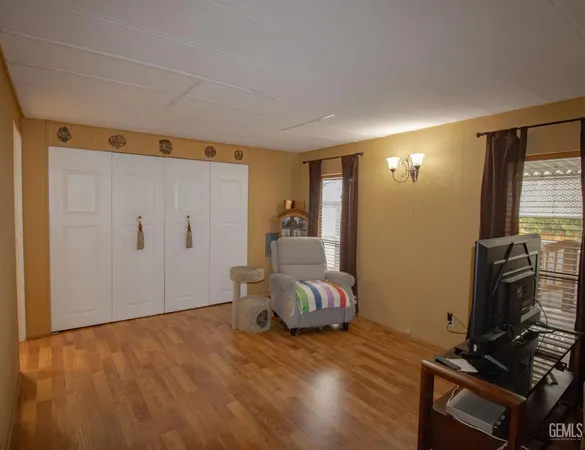 a bedroom with bed and wooden floor