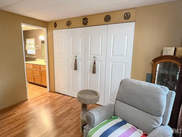 a bedroom with a bed and chair