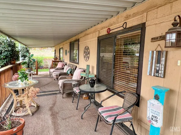 a building outdoor space with patio furniture and potted plants