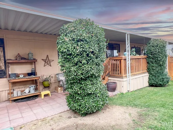 a view of backyard with potted plants and a wooden fence