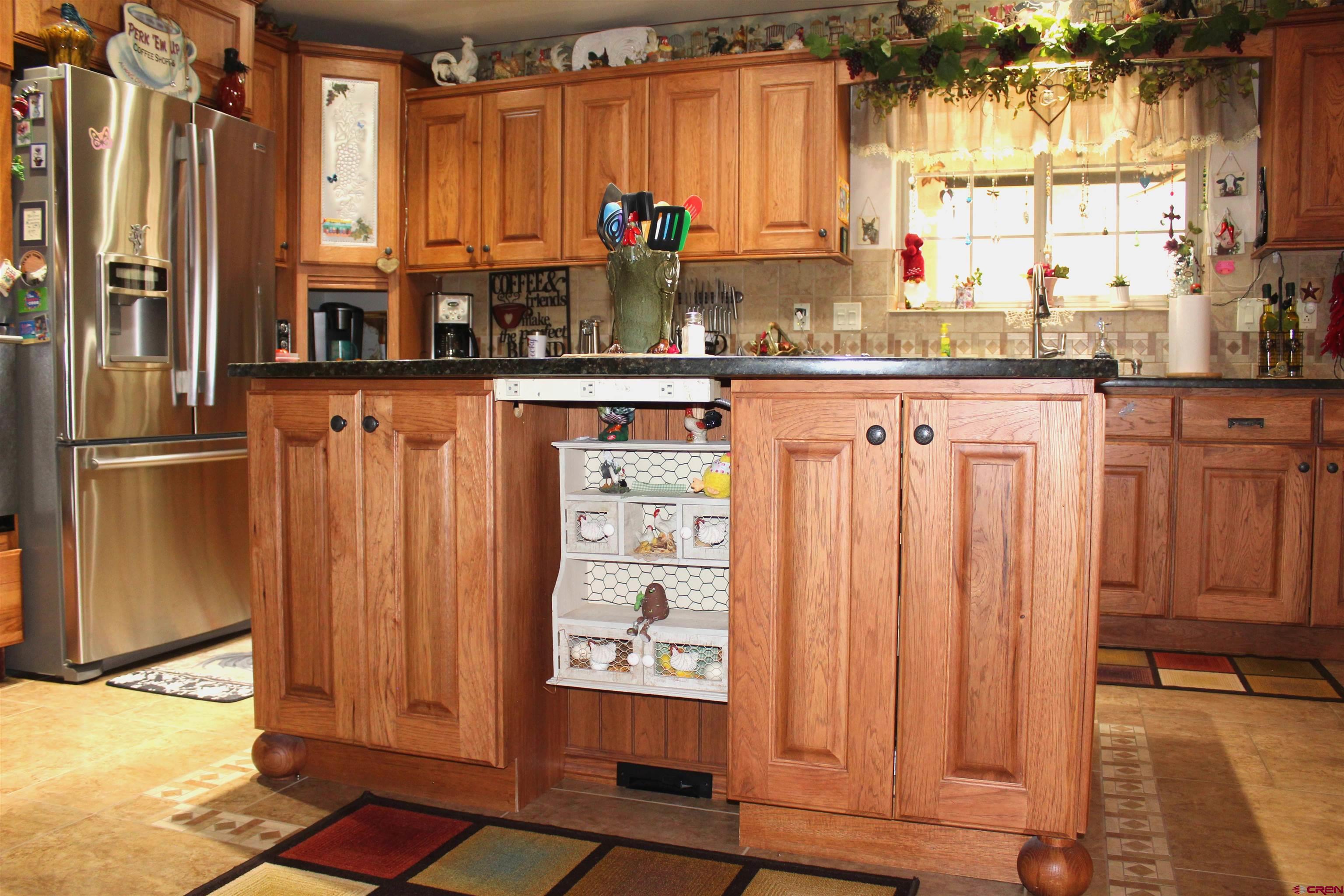 635 Northeast 2nd Street Cedaredge, CO 81413 - Photo 13 of 33 a kitchen with stainless steel appliances wooden floor and a window