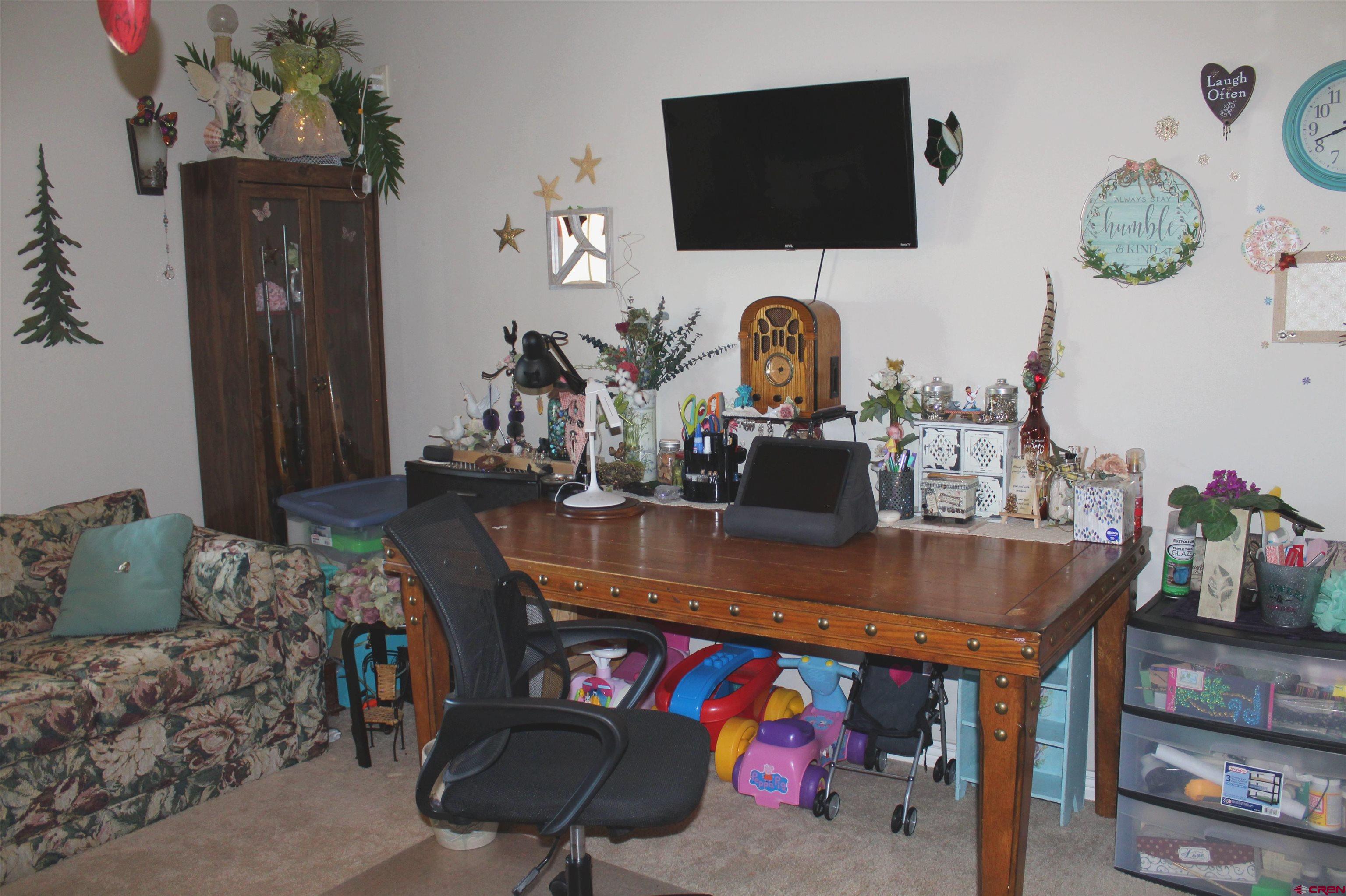 635 Northeast 2nd Street Cedaredge, CO 81413 - Photo 18 of 33 a living room with furniture and a flat screen tv