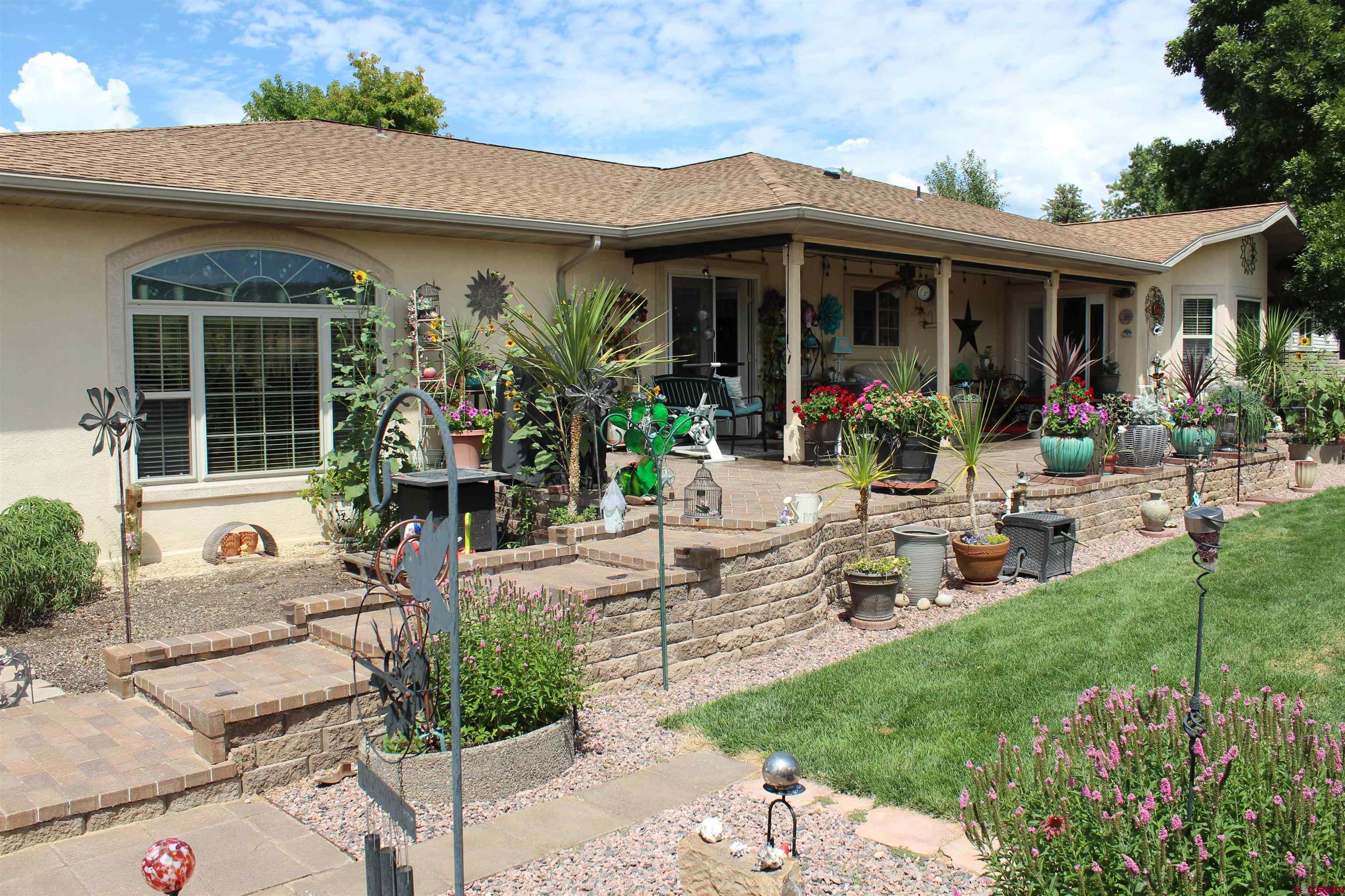 635 Northeast 2nd Street Cedaredge, CO 81413 - Photo 30 of 33 a view of a house with sitting area and garden