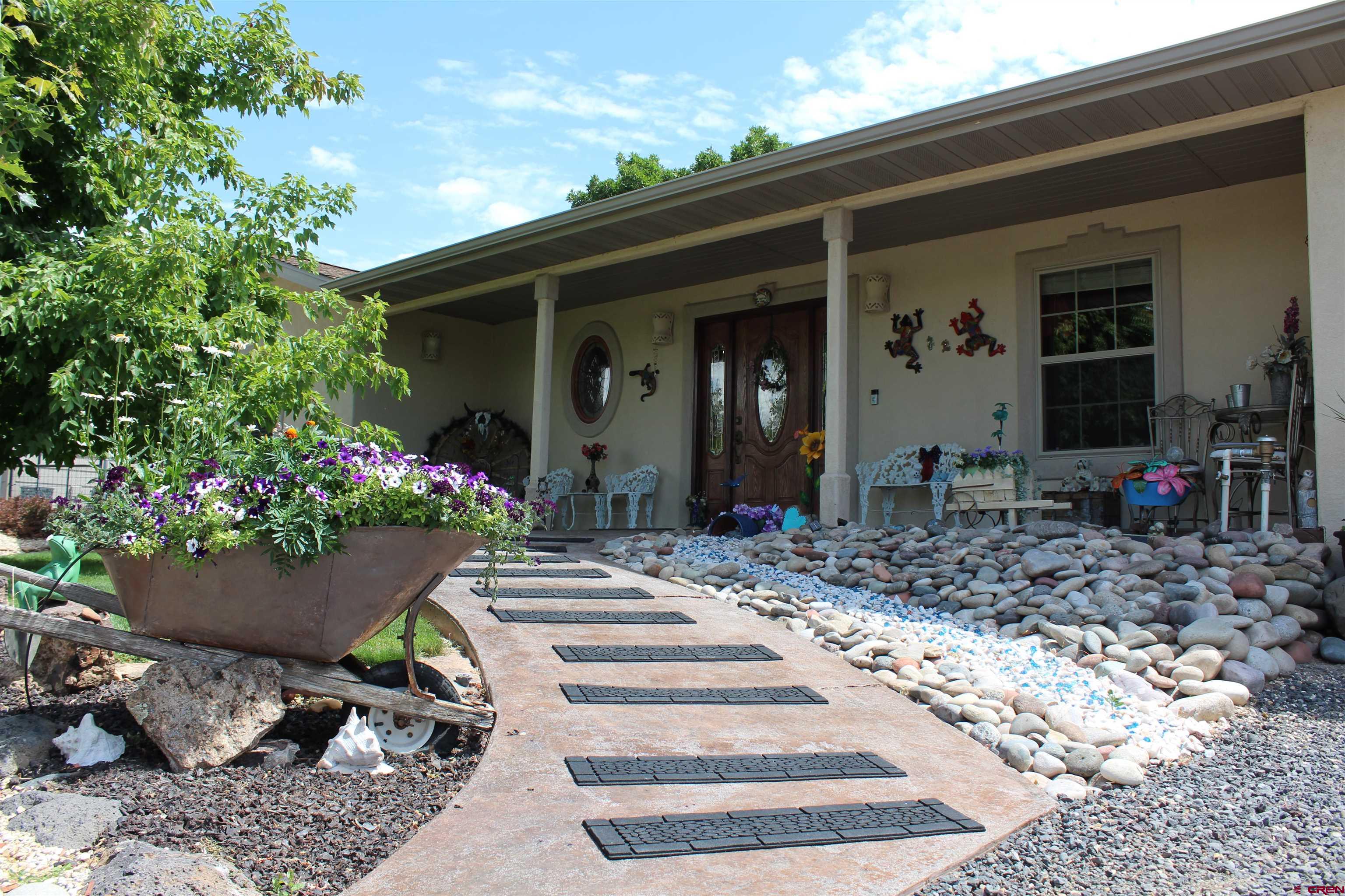 635 Northeast 2nd Street Cedaredge, CO 81413 - Photo 33 of 33 a front view of a house with garden