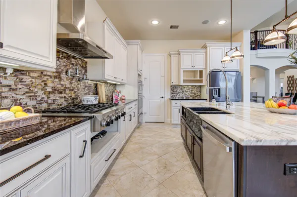 a kitchen with stainless steel appliances granite countertop a sink and a stove
