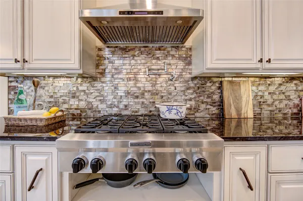 a kitchen with a stove and a white cabinet