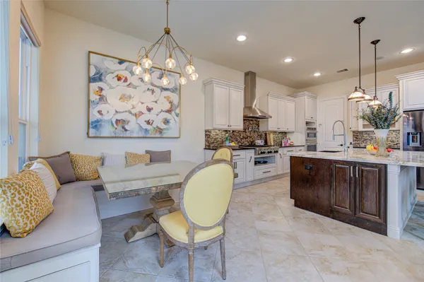 a living room with couches chairs and kitchen view