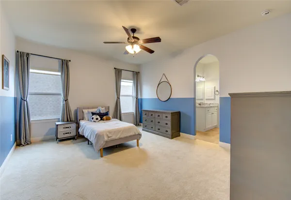 a bed room with a bed mirror and a window