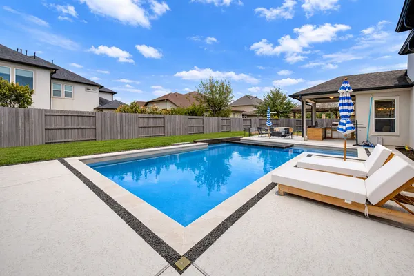 a view of a patio with swimming pool table and chairs